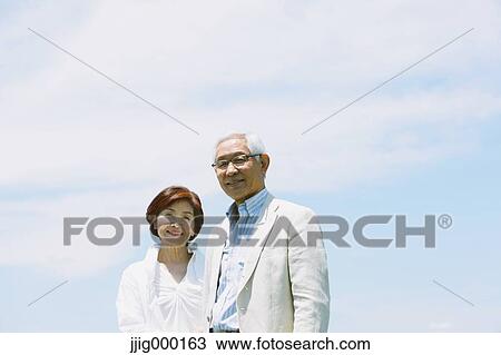 Senior couple smiling at camera View Large Photo Image Stock Image - Senior couple smiling at camera. Fotosearch