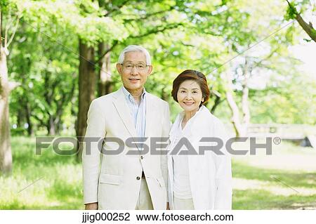 Stock Image - Senior couple smiling at camera. Fotosearch