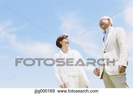 Senior couple smiling holding hands View Large Photo Image Stock Photo - Senior couple smiling holding hands. Fotosearch