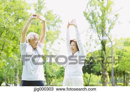 Stock Image - Senior couple training in a park. Fotosearch