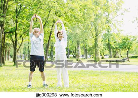 Senior couple training in a park View Large Photo Image Stock Photo - Senior couple training in a park. Fotosearch