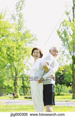 Stock Photograph - Senior couple training in a park. Fotosearch