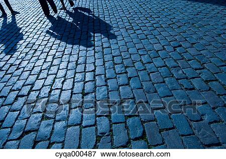 Stock Photo - Silhouettes on cobblestone. Fotosearch