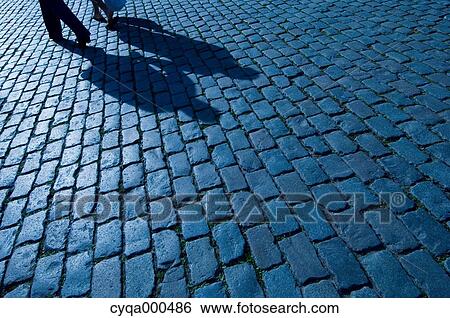 Silhouettes on cobblestone View Large Photo Image Stock Photograph - Silhouettes on cobblestone. Fotosearch