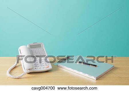 Telephone and file on wooden desk View Large Photo Image Stock Image - Telephone and file on wooden desk. Fotosearch