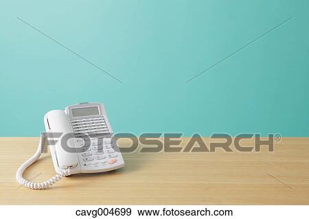 Telephone on wooden desk View Large Photo Image Stock Photo - Telephone on wooden desk. Fotosearch