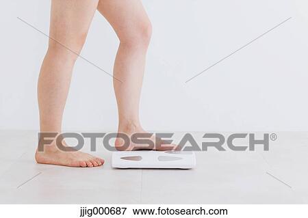Woman riding on weight scale View Large Photo Image Stock Photo - Woman riding on weight scale. Fotosearch