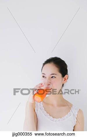 Young woman drinking vegetable juice View Large Photo Image Stock Photography - Young woman drinking vegetable juice. Fotosearch