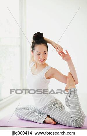 Picture - Young woman practicing yoga. Fotosearch