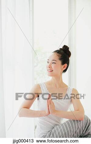 Young woman practicing yoga View Large Photo Image Stock Image - Young woman practicing yoga. Fotosearch