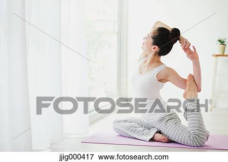 Stock Photo - Young woman practicing yoga. Fotosearch