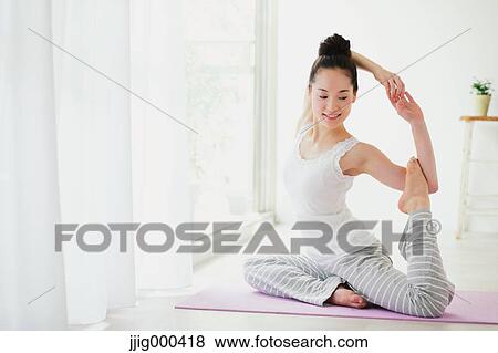 Young woman practicing yoga View Large Photo Image Stock Photo - Young woman practicing yoga. Fotosearch