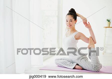 Young woman practicing yoga View Large Photo Image Stock Photo - Young woman practicing yoga. Fotosearch