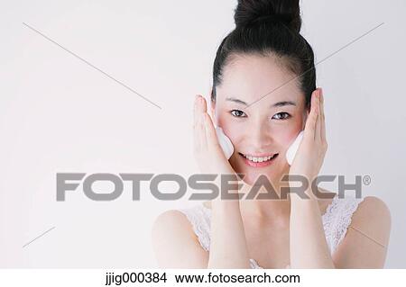 Young woman putting face-wash foam View Large Photo Image Picture - Young woman putting face-wash foam. Fotosearch