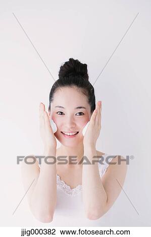 Young woman putting face-wash foam View Large Photo Image Stock Image - Young woman putting face-wash foam. Fotosearch