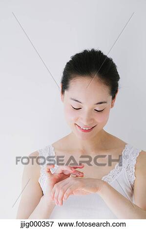 Young woman putting foundation cream View Large Photo Image Stock Photo - Young woman putting foundation cream. Fotosearch