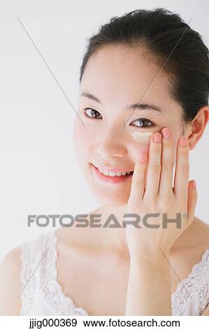 Young woman putting foundation cream View Large Photo Image Stock Photo - Young woman putting foundation cream. Fotosearch