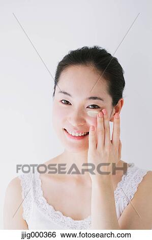 Young woman putting foundation cream View Large Photo Image Stock Photograph - Young woman putting foundation cream. Fotosearch