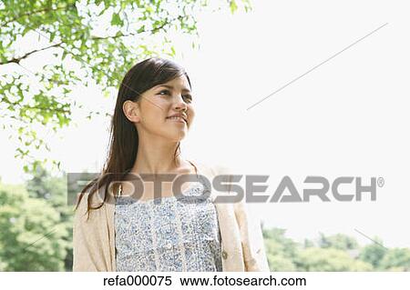 Stock Photography - Young woman smiling away. Fotosearch