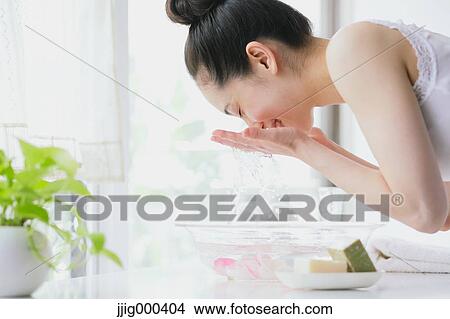 Young woman washing face View Large Photo Image Picture - Young woman washing face. Fotosearch