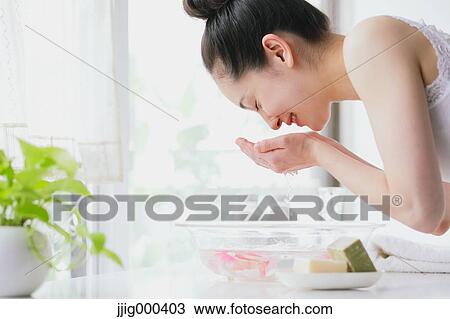 Young woman washing face View Large Photo Image Stock Image - Young woman washing face. Fotosearch