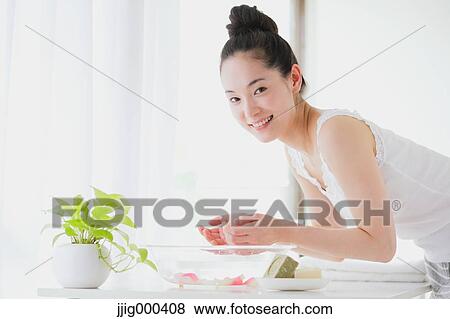 Stock Photo - Young woman washing face. Fotosearch