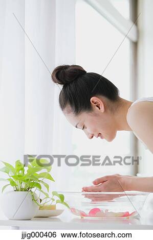Stock Photograph - Young woman washing face. Fotosearch