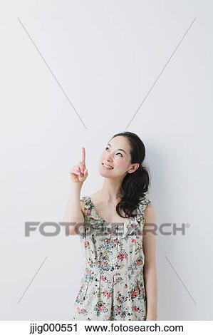 Young woman wearing one piece pointing a finger View Large Photo Image Stock Image - Young woman wearing one piece pointing a finger. Fotosearch