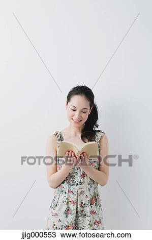 Young woman wearing one piece reading a book View Large Photo Image Stock Image - Young woman wearing one piece reading a book. Fotosearch