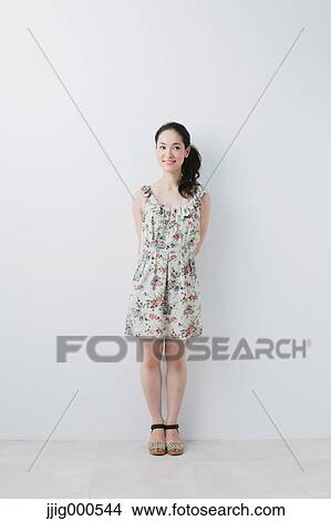 Picture - Young woman wearing one piece smiling away. Fotosearch