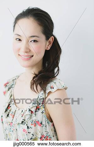 Stock Photography - Young woman wearing one piece smiling. Fotosearch