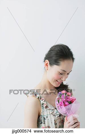 Young woman wearing one piece with a bouquet View Large Photo Image Picture - Young woman wearing one piece with a bouquet. Fotosearch