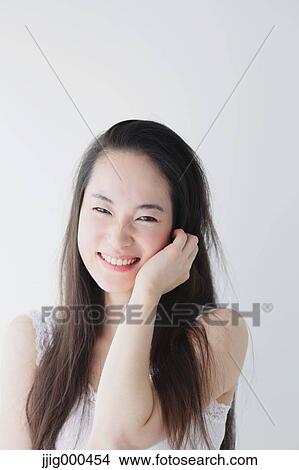 Picture - Young woman with long hair smiling. Fotosearch