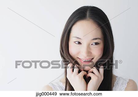 Stock Photo - Young woman with long hair smiling. Fotosearch
