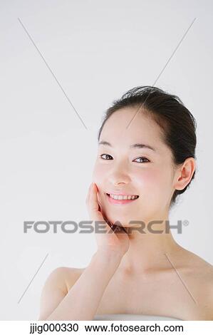 Young woman with no make-up smiling at camera View Large Photo Image Stock Image - Young woman with no make-up smiling at camera. Fotosearch