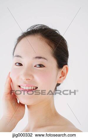 Young woman with no make-up smiling at camera View Large Photo Image Stock Image - Young woman with no make-up smiling at camera. Fotosearch