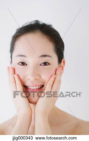 Young woman with no make-up smiling at camera View Large Photo Image Stock Image - Young woman with no make-up smiling at camera. Fotosearch