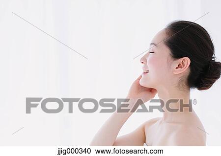 Stock Image - Young woman with no make-up smiling. Fotosearch