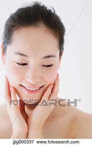 Stock Photo - Young woman with no make-up smiling. Fotosearch