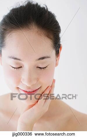 Young woman with no make-up smiling with closed eyes View Large Photo Image Stock Photograph - Young woman with no make-up smiling with closed eyes. Fotosearch