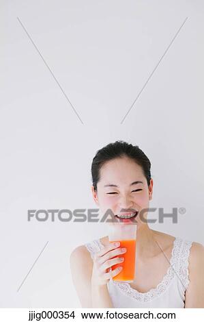 Young woman with vegetable juice smiling View Large Photo Image Picture - Young woman with vegetable juice smiling. Fotosearch