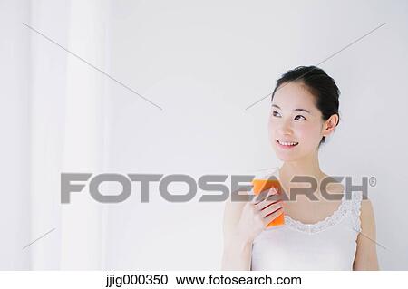 Young woman with vegetable juice smiling away View Large Photo Image Stock Image - Young woman with vegetable juice smiling away. Fotosearch