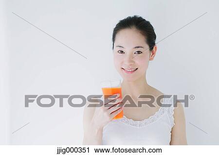 Young woman with vegetable juice smiling at camera View Large Photo Image Stock Image - Young woman with vegetable juice smiling at camera. Fotosearch