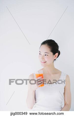 Young woman with vegetable juice smiling away View Large Photo Image Stock Photo - Young woman with vegetable juice smiling away. Fotosearch