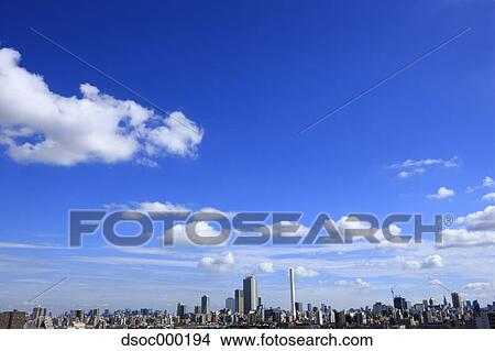 Picture - Blue sky with clouds and cityscape. Fotosearch