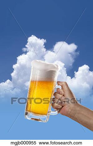 Stock Photography - Glass of beer and sky in the background. Fotosearch