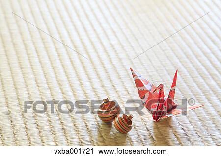 Origami crane and spinning tops on tatami mat View Large Photo Image Stock Image - Origami crane and spinning tops on tatami mat. Fotosearch