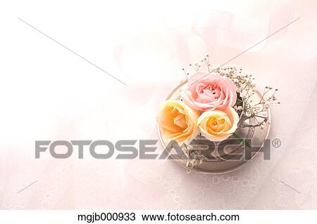 Stock Image - Roses of various colors in a metal cup. Fotosearch