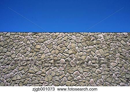 Stock Image - Stone wall and blue sky. Fotosearch