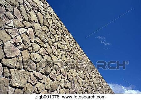 Stock Photograph - Stone wall and blue sky. Fotosearch
